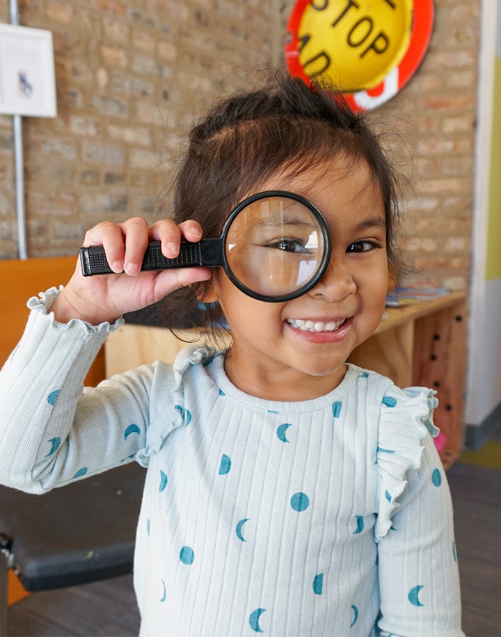 Preschool-Kindergarten student with magnifying glass