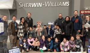A kindergarten class and teachers at Sherwin Williams to explore how paint is made and used.