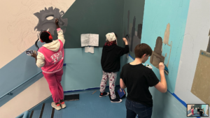 Students paint a mural as part of their project-based learning course.