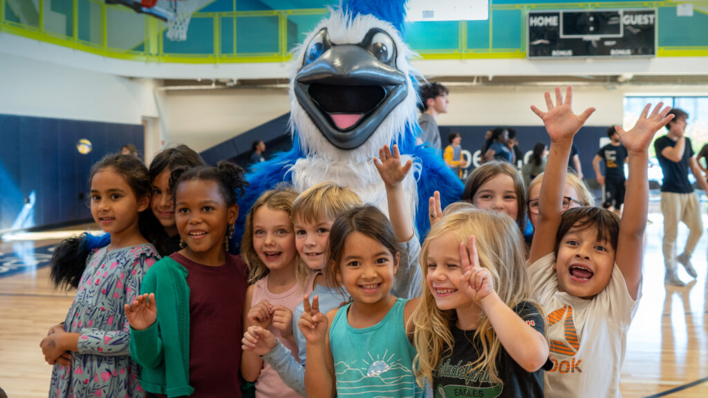 elementary school students show school pride with the blue jay mascot